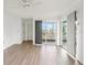 Bright living room with wood-look floors and sliding glass doors leading to a balcony at 7304 W Country Club N Dr # 213, Sarasota, FL 34243