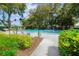 Community pool with lounge chairs and lush landscaping at 7304 W Country Club N Dr # 213, Sarasota, FL 34243