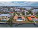 Aerial view of waterfront home with pool and private dock at 740 Old Compass Rd, Longboat Key, FL 34228