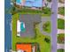 Bird's-eye view showcasing home's unique layout, pool, and canal-side location at 740 Old Compass Rd, Longboat Key, FL 34228
