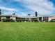Large backyard with lush green grass and a long view of the house at 740 Old Compass Rd, Longboat Key, FL 34228