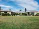 Backyard view of the home showcasing manicured lawn at 740 Old Compass Rd, Longboat Key, FL 34228