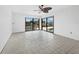 Empty bonus room with tile floors and sliding doors leading to a pool and canal view at 740 Old Compass Rd, Longboat Key, FL 34228