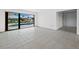 Bright living room with tile floors and sliding glass doors to the pool at 740 Old Compass Rd, Longboat Key, FL 34228