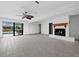 Spacious living room with fireplace and sliding doors opening to a pool and patio at 740 Old Compass Rd, Longboat Key, FL 34228