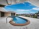 Inviting kidney-shaped pool with spacious patio, offering water views at 740 Old Compass Rd, Longboat Key, FL 34228
