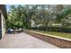 Landscaped backyard with a brick patio and privacy wall at 7728 Rio Bella Pl, Bradenton, FL 34201