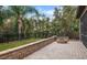 Relaxing backyard patio with fire pit and built-in seating wall at 7728 Rio Bella Pl, Bradenton, FL 34201