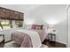 Bright bedroom with double bed, window, and dark wood floors at 7728 Rio Bella Pl, Bradenton, FL 34201