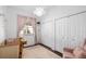 Bedroom featuring a crib, dresser, and ample closet space at 7728 Rio Bella Pl, Bradenton, FL 34201