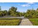 Paved path meanders through community's lush green landscape at 7728 Rio Bella Pl, Bradenton, FL 34201