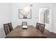 Bright dining room with hardwood floors and modern light fixture at 7728 Rio Bella Pl, Bradenton, FL 34201