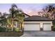 Two-story home with tile roof, two-car garage, and landscaped yard at 7728 Rio Bella Pl, Bradenton, FL 34201