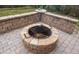 Round fire pit with grill perfect for outdoor cooking and entertaining at 7728 Rio Bella Pl, Bradenton, FL 34201