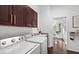 Laundry room with washer, dryer, cabinets, and a folding counter at 7728 Rio Bella Pl, Bradenton, FL 34201