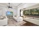 Living room with white sofas, large TV, and access to screened patio at 7728 Rio Bella Pl, Bradenton, FL 34201