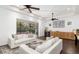 Living room with white sofas, wood floors, and sliding glass doors at 7728 Rio Bella Pl, Bradenton, FL 34201