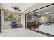 Covered outdoor patio with built-in grill and view of living room at 7728 Rio Bella Pl, Bradenton, FL 34201