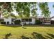 Spacious backyard with lush green grass, bird bath and a screened lanai at 807 62Nd W St, Bradenton, FL 34209