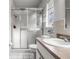 Bathroom with a shower featuring sliding glass doors and vanity with a large mirror at 807 62Nd W St, Bradenton, FL 34209