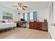 Bedroom featuring a window, ceiling fan, large closet, and a vintage dresser at 807 62Nd W St, Bradenton, FL 34209
