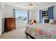 Bright bedroom with a large window, ceiling fan, and charming decor at 807 62Nd W St, Bradenton, FL 34209