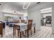 Open dining area with views into the living room and kitchen, tiled floors and updated lighting at 807 62Nd W St, Bradenton, FL 34209