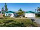 Charming single-story home with well-manicured lawn, blue trim, and attached garage at 807 62Nd W St, Bradenton, FL 34209