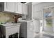Bright laundry room with sink, washer, and dryer, offering convenience and functionality at 807 62Nd W St, Bradenton, FL 34209