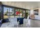 A cozy sunroom featuring screened windows, tiled flooring, and a quaint table setting at 807 62Nd W St, Bradenton, FL 34209