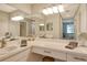 Bright bathroom with double vanity and a large mirror at 8750 Olde Hickory Ave # 9205, Sarasota, FL 34238
