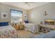 Guest bedroom with twin beds and coastal-themed bedding at 8750 Olde Hickory Ave # 9205, Sarasota, FL 34238