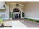 Stone building entrance to Stonebridge, featuring double doors and landscaping at 8750 Olde Hickory Ave # 9205, Sarasota, FL 34238