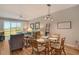 Dining area with glass table and wicker chairs, open to kitchen at 8750 Olde Hickory Ave # 9205, Sarasota, FL 34238