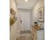 Bright entryway with a decorative console table and beach-themed decor at 8750 Olde Hickory Ave # 9205, Sarasota, FL 34238