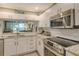 Modern kitchen with stainless steel appliances and granite countertops at 8750 Olde Hickory Ave # 9205, Sarasota, FL 34238