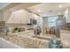 Modern kitchen with granite countertops and stainless steel appliances at 8750 Olde Hickory Ave # 9205, Sarasota, FL 34238