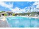 Relaxing community pool with surrounding lounge chairs at 8750 Olde Hickory Ave # 9205, Sarasota, FL 34238