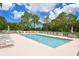 Community pool with plenty of lounge chairs for relaxation at 8750 Olde Hickory Ave # 9205, Sarasota, FL 34238
