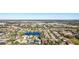 Aerial view showing a neighborhood near a large shopping center and lakes at 8818 29Th E St, Parrish, FL 34219