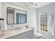 Updated bathroom with modern vanity and a large block window at 8818 29Th E St, Parrish, FL 34219