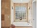 Relaxing bathroom with a jetted tub and a large window at 8818 29Th E St, Parrish, FL 34219