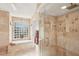 Spa-like bathroom with soaking tub, walk-in shower, and tile finishes at 8818 29Th E St, Parrish, FL 34219