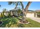 House exterior with mature trees and manicured lawn at 8818 29Th E St, Parrish, FL 34219