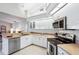 Modern kitchen with stainless steel appliances and white cabinets at 8818 29Th E St, Parrish, FL 34219