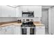 Kitchen features stainless steel appliances and white cabinets at 8818 29Th E St, Parrish, FL 34219