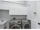 Laundry room with white cabinets, washer, and dryer at 8818 29Th E St, Parrish, FL 34219