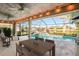 Relaxing screened pool area with patio furniture and lake view at 8818 29Th E St, Parrish, FL 34219