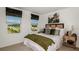 Cozy bedroom with a queen bed and wood framed artwork at 8958 Daybreak St, Sarasota, FL 34241