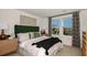Spacious bedroom with a green velvet headboard and large windows at 8958 Daybreak St, Sarasota, FL 34241
